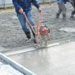 How is calcium lignosulfonate used as a water reducer in concrete?