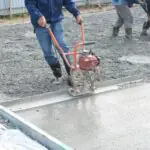 How is calcium lignosulfonate used as a water reducer in concrete?