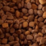 Why is calcium lignosulfonate used in animal feed pellets?