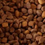 Why is calcium lignosulfonate used in animal feed pellets?